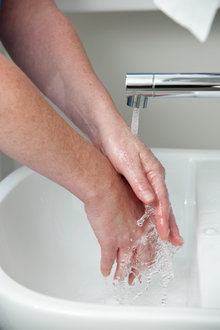 Photo showing hands underneath a tap with running water